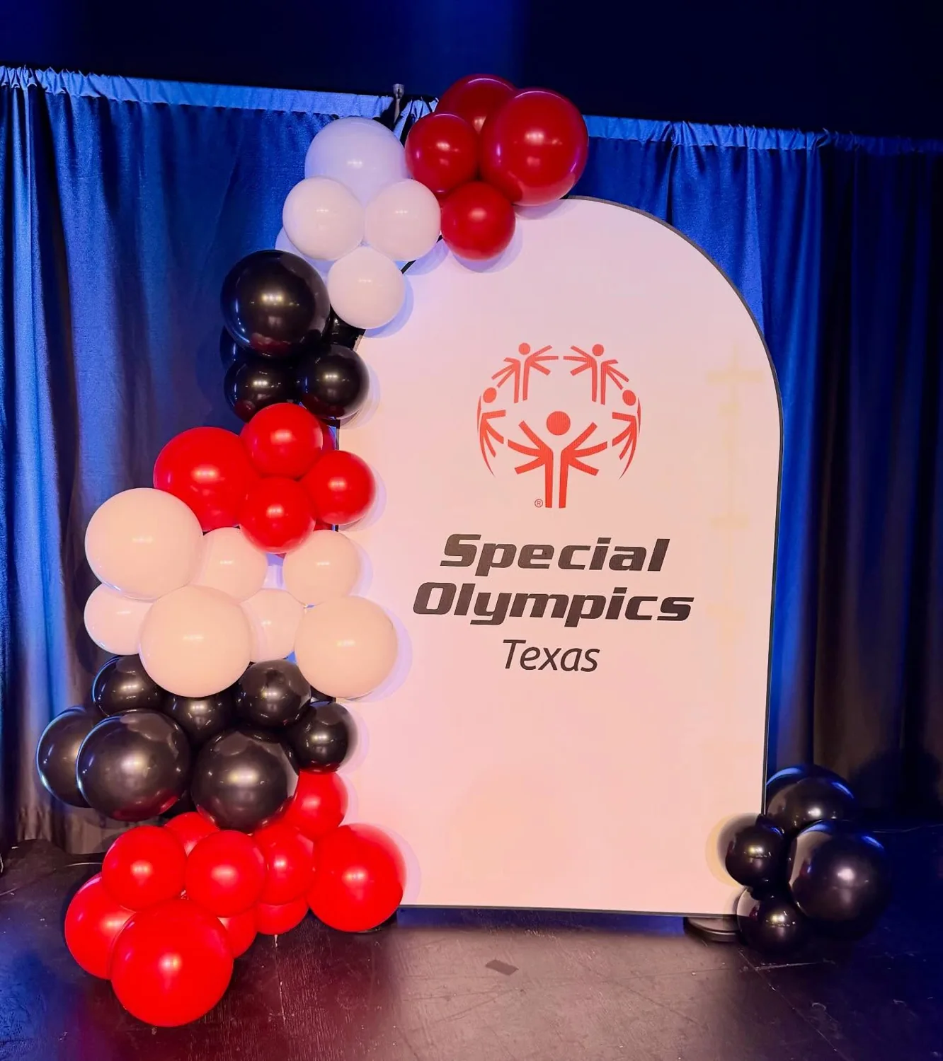 Special Olympics Texas red, white and black balloon display